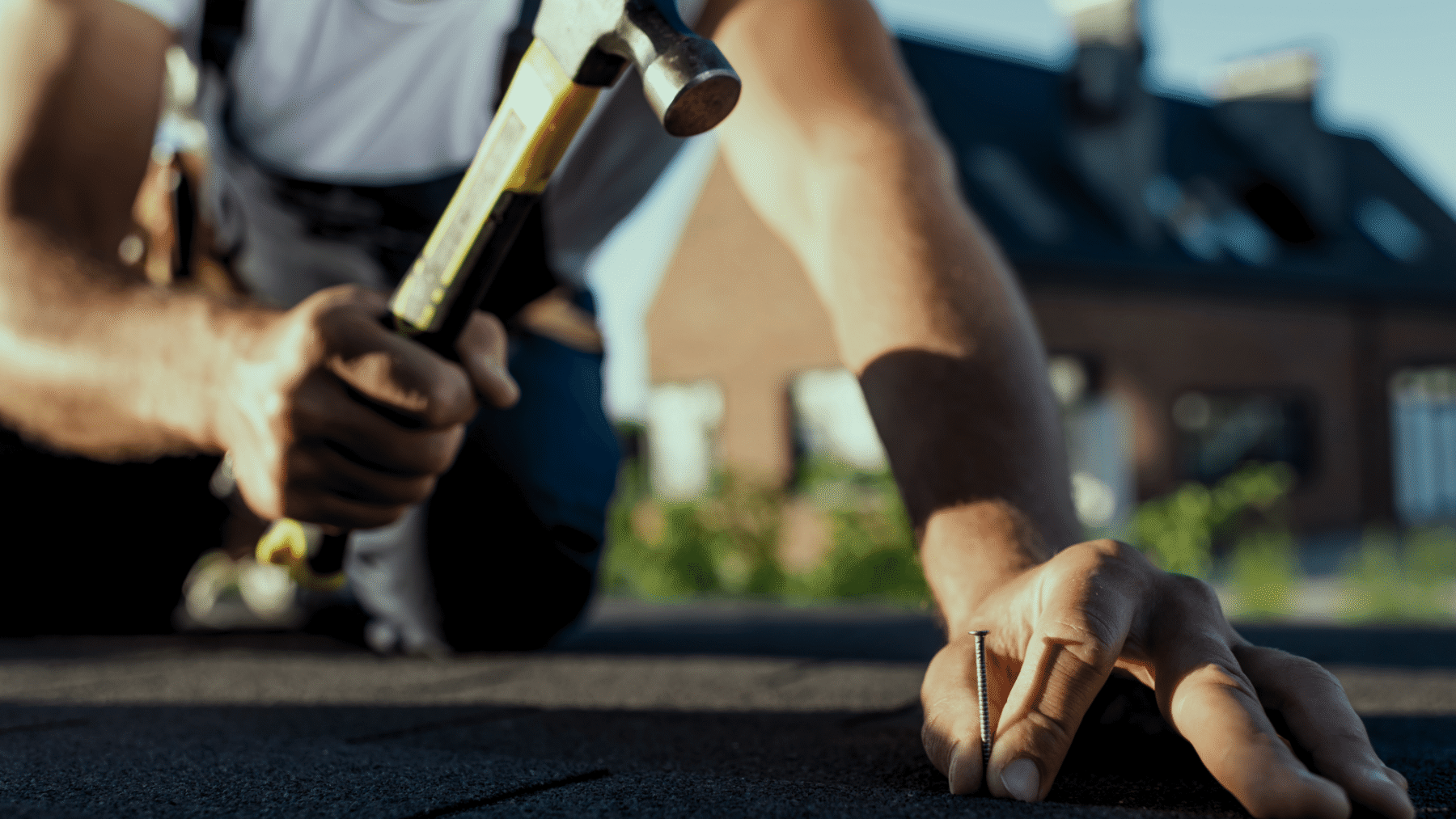 Roofer Hammering a nail