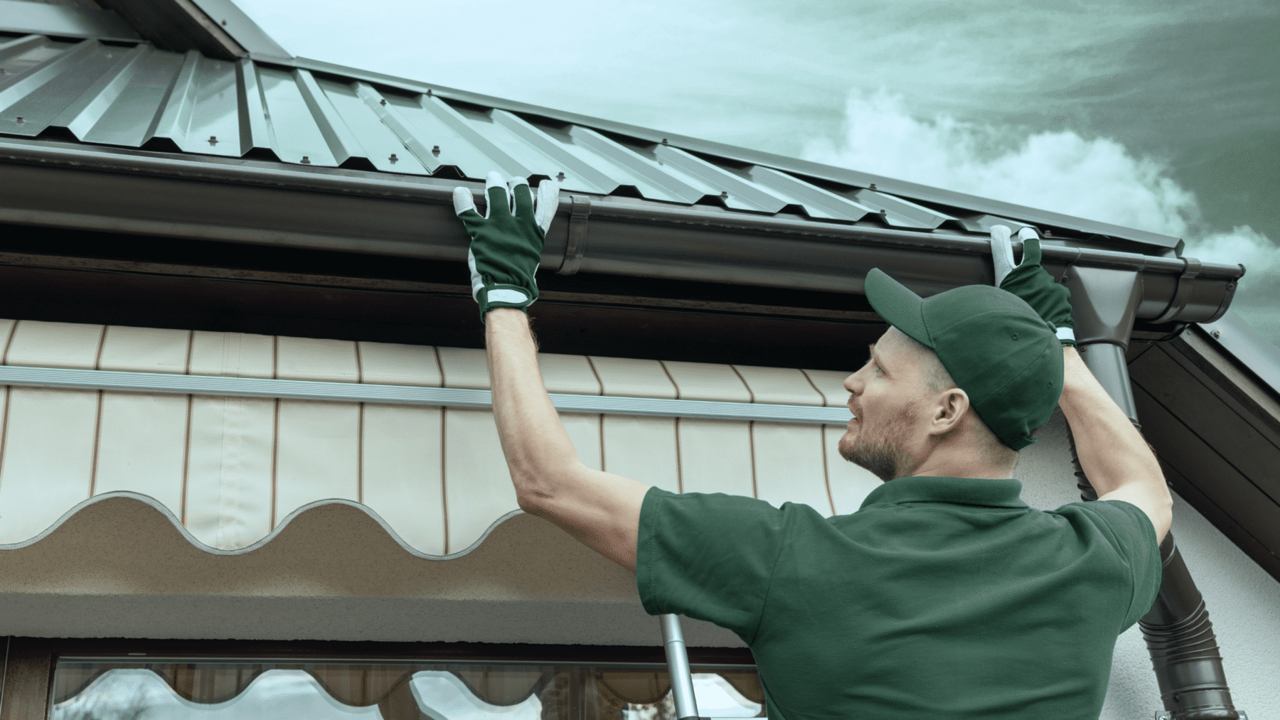 Roofer installing a gutter