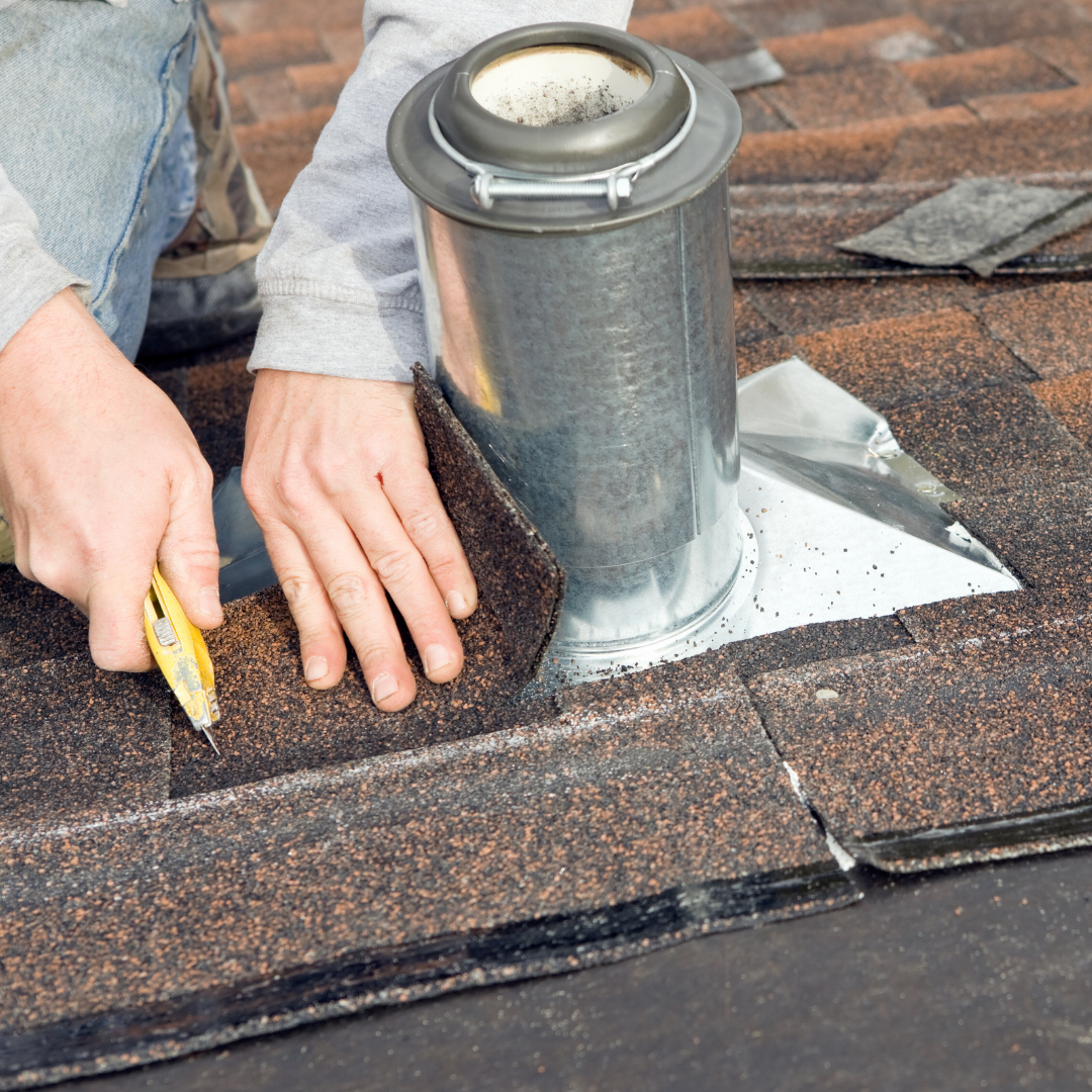 Man repairing roof shingles