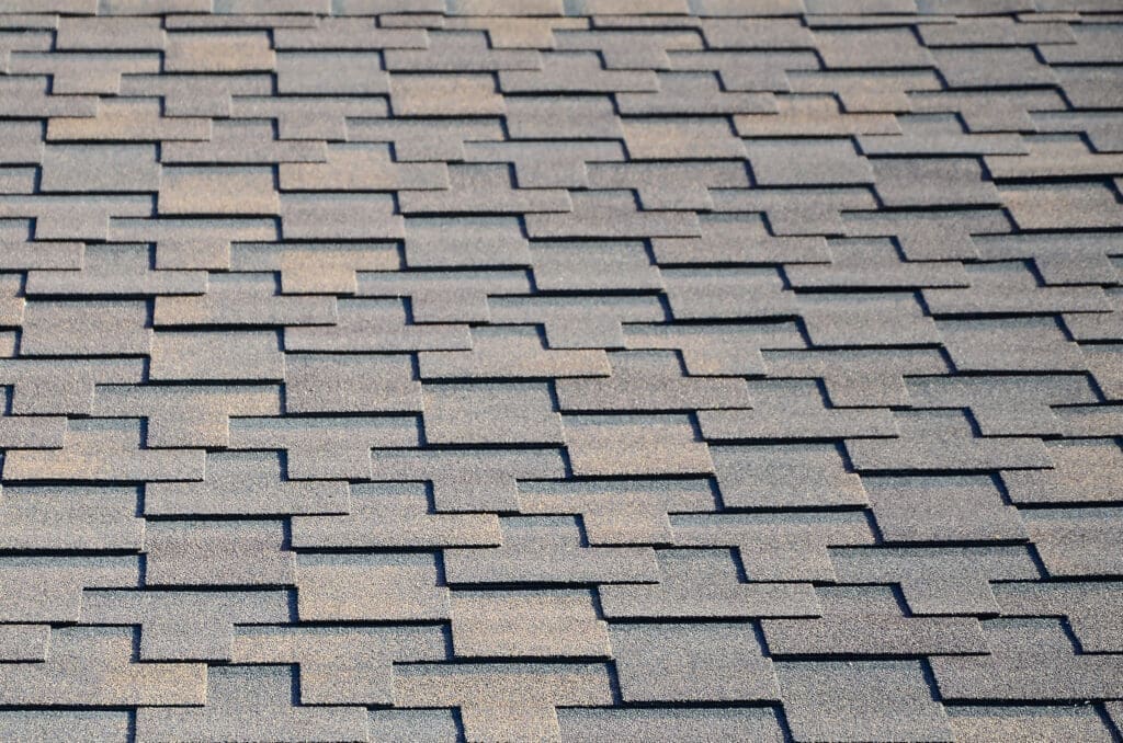 Modern roofing and decoration of chimneys. Flexible bitumen or slate shingles in rectangular shape in perspective.