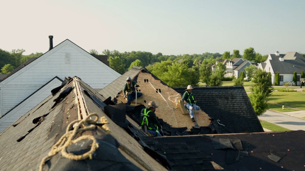 Roofers removing an old roof and putting on a new one